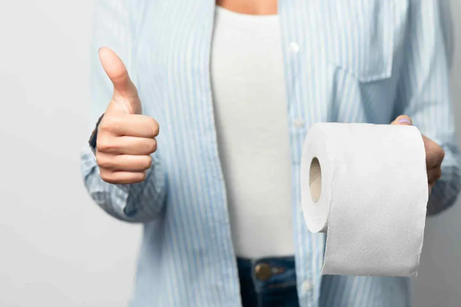 Woman Holding Toilet Paper Gesturing Thumbs-Up